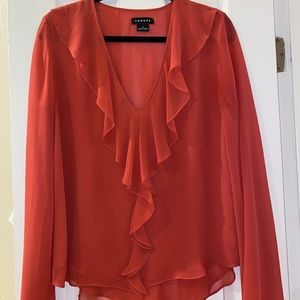 orange/coral Trouve blouse. subtle ruffles on the neckline. subtle flare sleeves